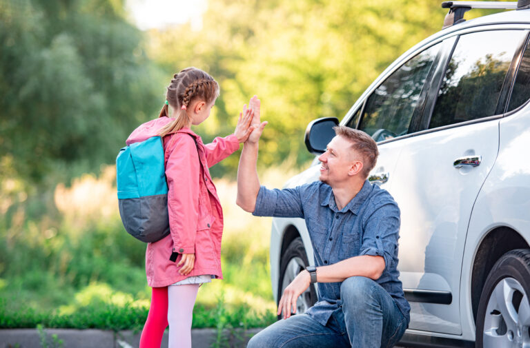 Father and daughter high-fiving