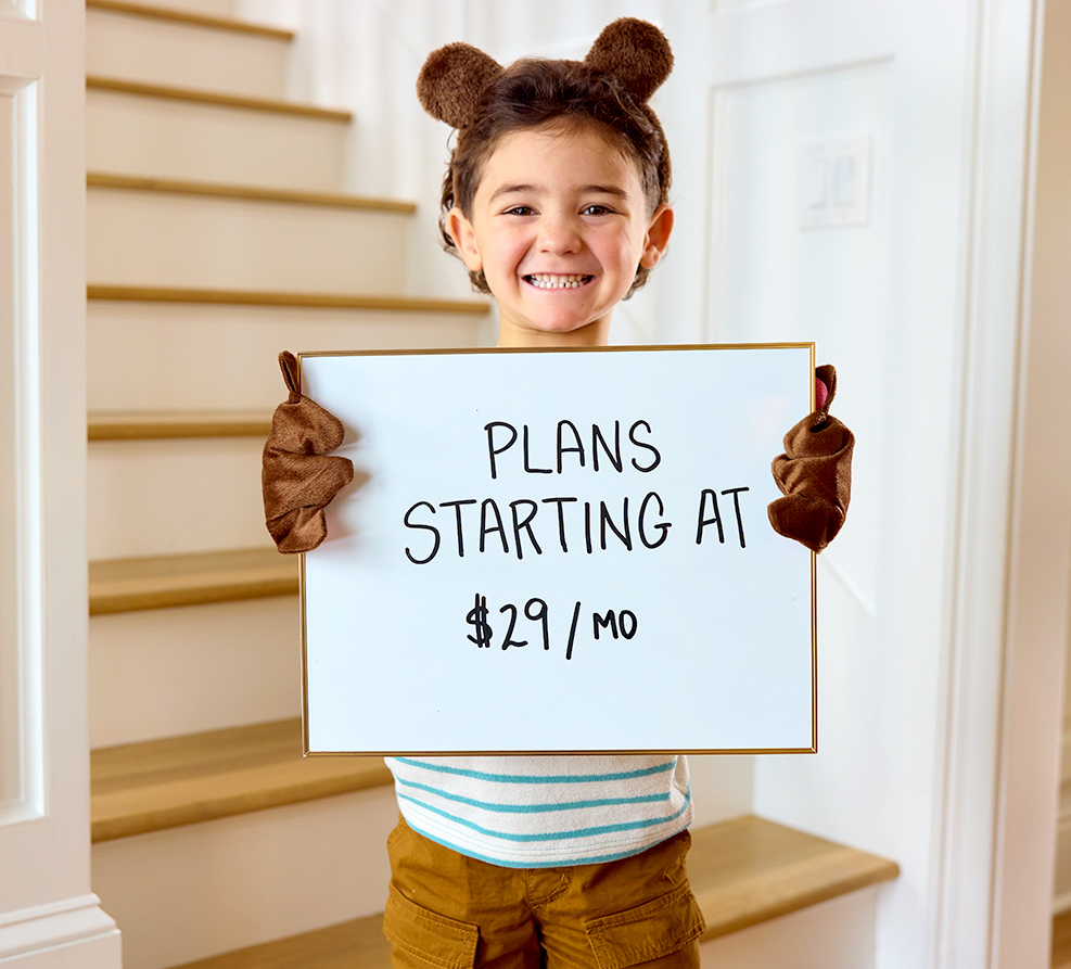 Boy holding sign for low prices